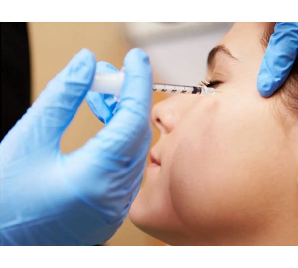 a women getting an injection on her cheek area