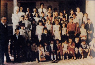 Black and white group photo of children and adults.