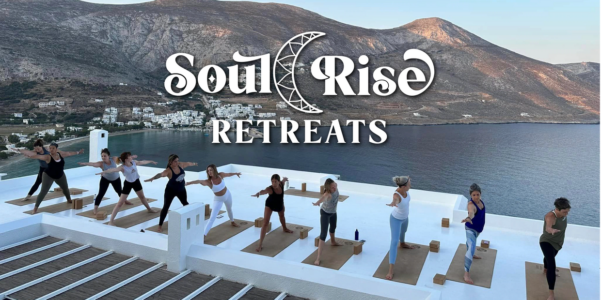 Yogis standing on their mats during a rooftop yoga class overlooking the Aegean Sea in Greece