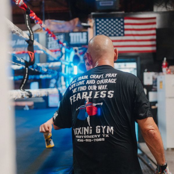 Man in a boxing gym with an inspirational shirt.