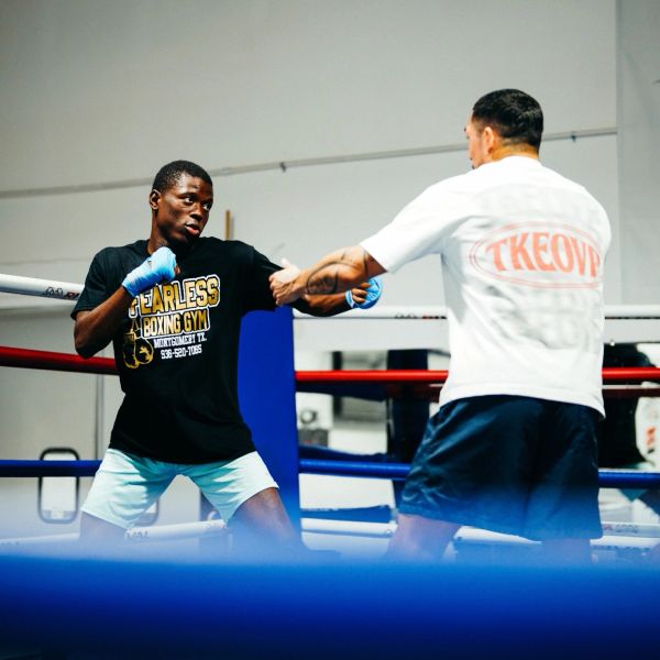 Two men sparring in a boxing ring.