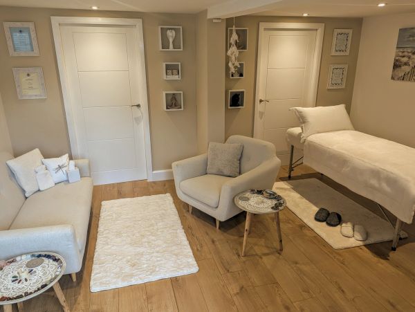 Cozy therapy or massage room with neutral decor.
