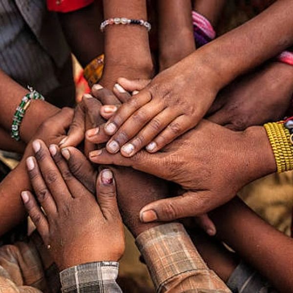 Many hands joined together showing unity.