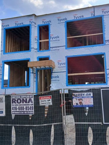 New house under construction wrapped in Tyvek sheeting.