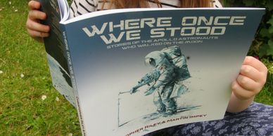 Reading a copy of Where Once We Stood