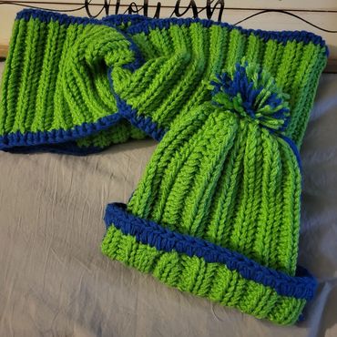 Sport team and school colored custom items available. 
Displayed: Seahawk color cowl and pom pom hat!