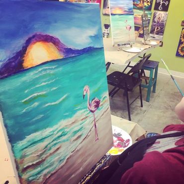 Beachy sunset with sand and pink flamingo on beach in Acrylic. White waves out to sea.