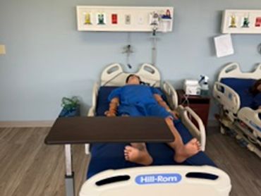 Manikin in a Hill-Rom Versacare bed. VESL medical built Headwall
