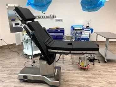 Modern operating room with surgical chair and equipment. Steris 3080 and steris 3085