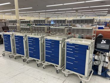 Row of empty Refurbished medical carts in a large room. Set for training students