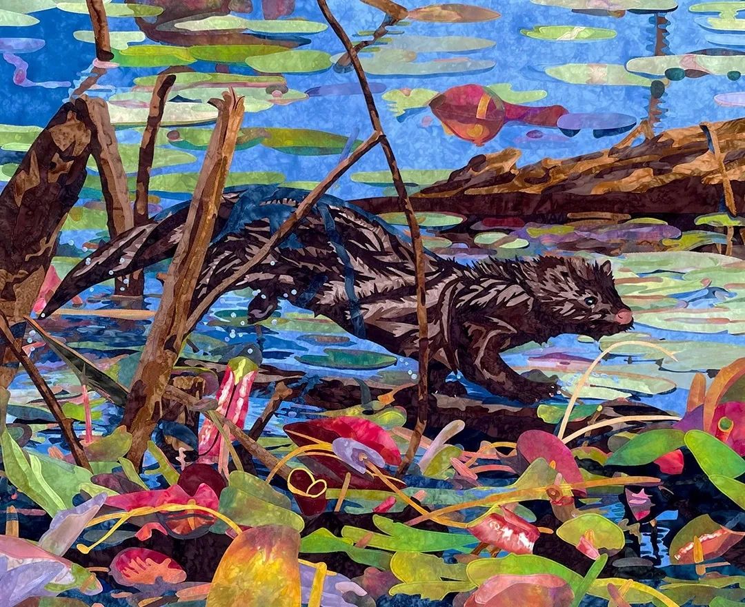 Fabric collage of an American Mink jumping on a log in water with lily pad leaves in the foreground