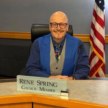 Council member Rene Spring seated at his desk.
