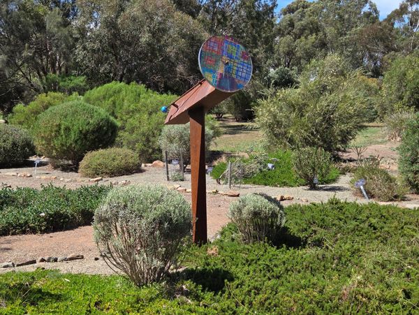 Colorful sundial in a garden.