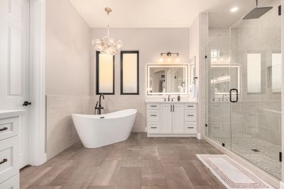Modern bathroom with freestanding tub, glass shower, and sleek vanity.