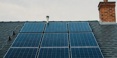 Solar panels installed on a residential roof under a clear sky.