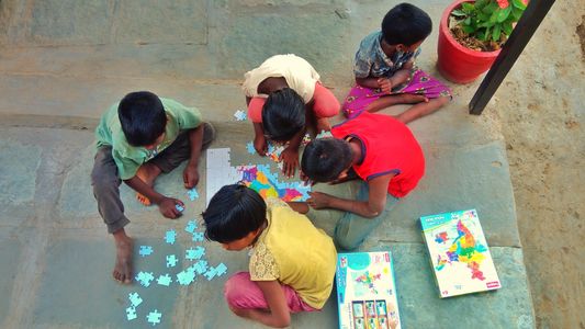 Kids solving puzzle of map of India at Snehgram