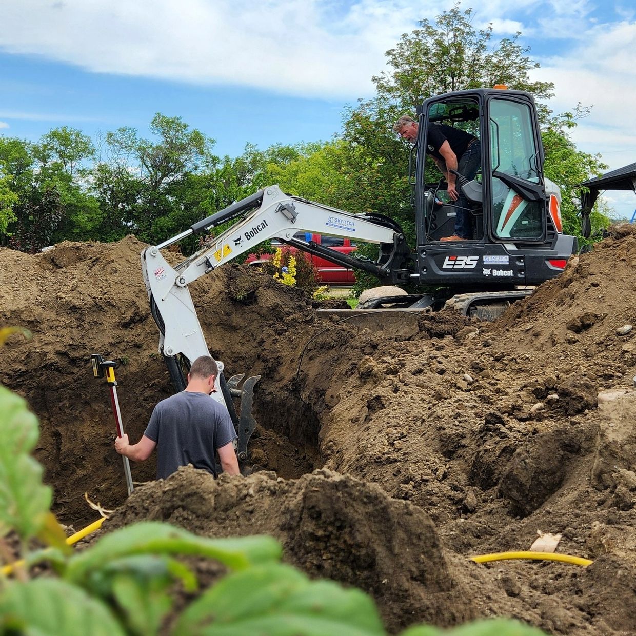 K&S Contracting team using an excavator to dig a foundation footing
