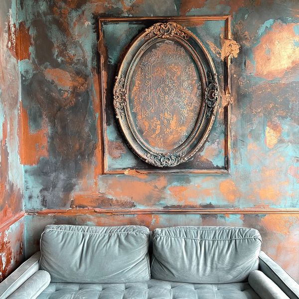 Vintage teal sofa in antique setting