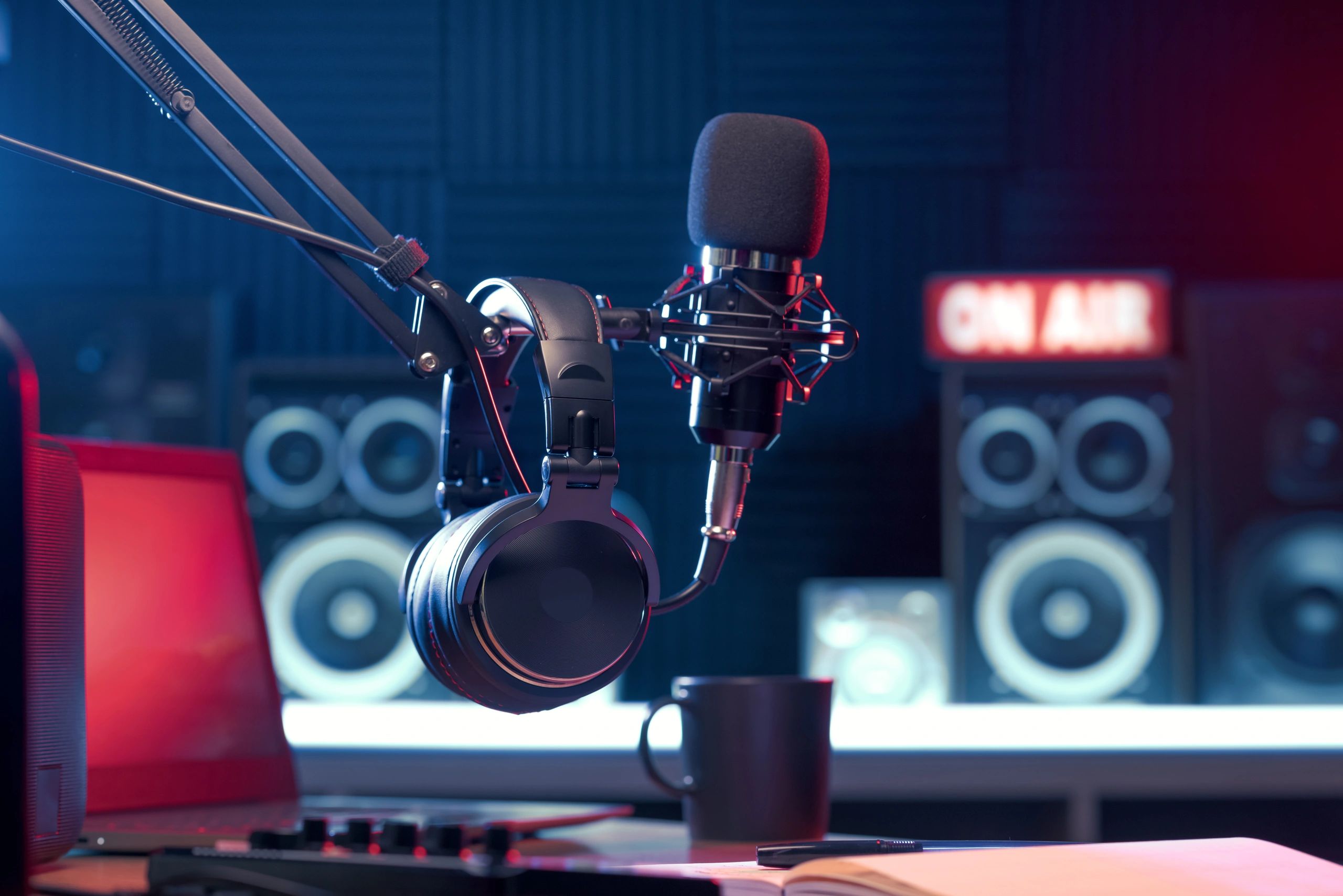 A close-up of a microphone and headphones in a recording studio.