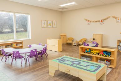 Bright and organized children's classroom with tables, chairs, and toys.