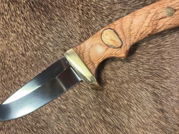 Knife with wooden handle on fur.