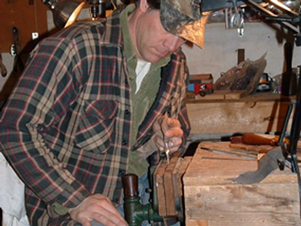 Hand sanding a custom knife handle