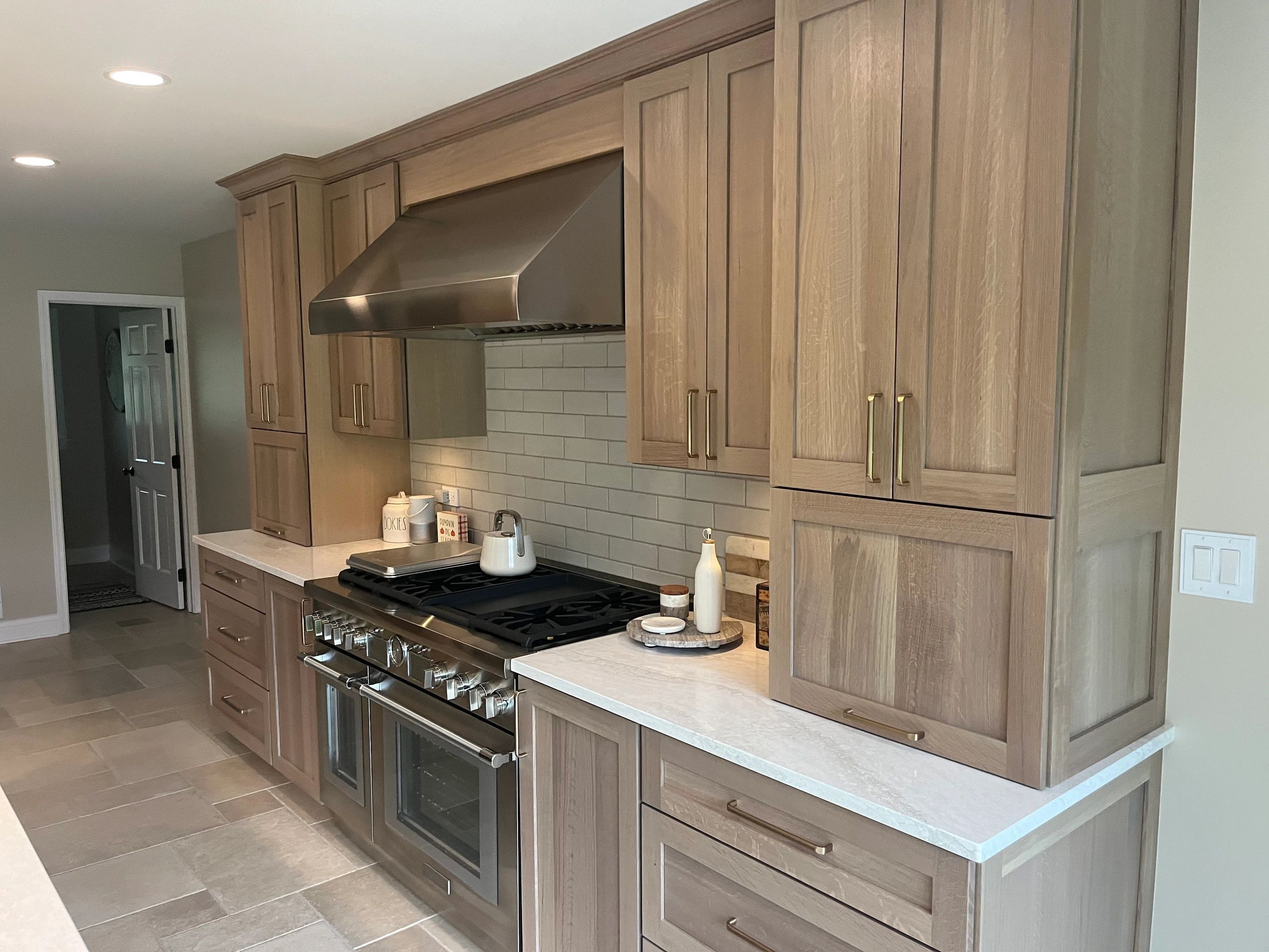 Stack of books next to pencils in a holder and a camera.