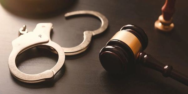 Picture of handcuffs and lawyer hammer