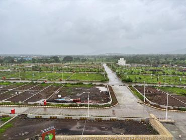 Overcast sky over a green, organized field with pathways.
na plot layout with concrete internal roads in third mumbai
mumbai third properties
sankalp meadows
riyasat infra
riyasat