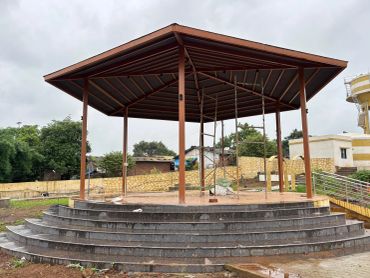 Hexagonal pavilion with central scaffolding on stone steps.
modern gazebo and pavilion area at na plot township in third mumbai
mumbai third properties
sankalp meadows
riyasat infra
riyasat