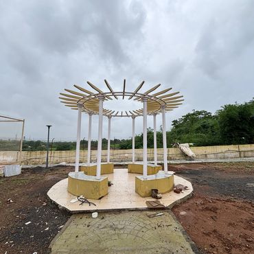 Circular outdoor structure with benches under cloudy sky.
landscaped garden with pergola seating in third mumbai residential plots
mumbai third properties
sankalp meadows
riyasat infra
riyasat