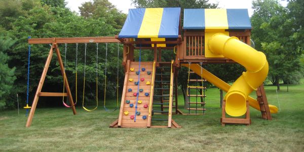 A picture of the swing set and the yellow slider