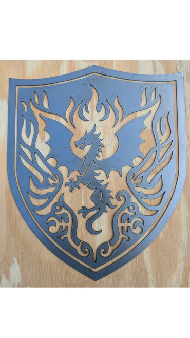 Metal dragon emblem on a wooden background.