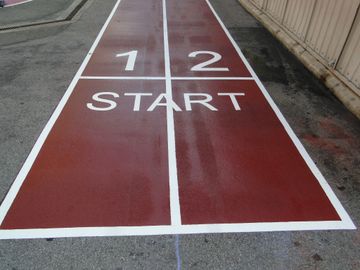 running track ground graphic game from preformed thermoplastic on asphalt by surface signs of NY