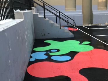 custom ground graphics made from preformed thermoplastic on asphalt in a playground by Surface signs