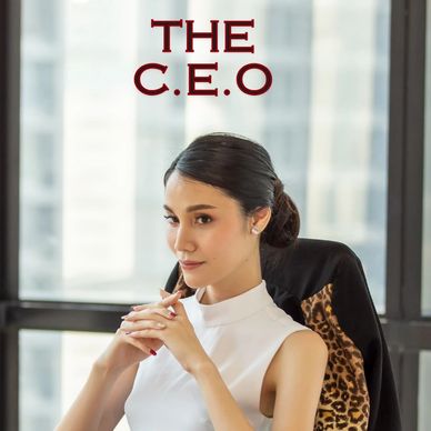 Confident woman CEO seated in office with focused expression.
