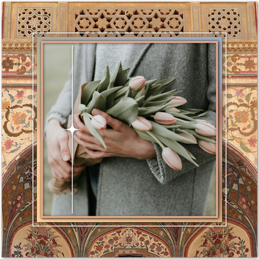 A lady holds a beautiful bouquet of pink tulips
