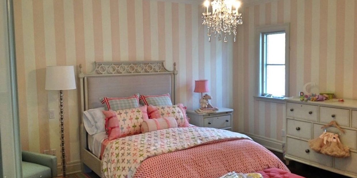 Interior girls bedroom featuring pink striped wallpaper