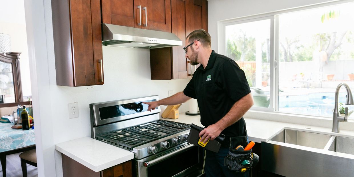 A person is inspecting the kitchen