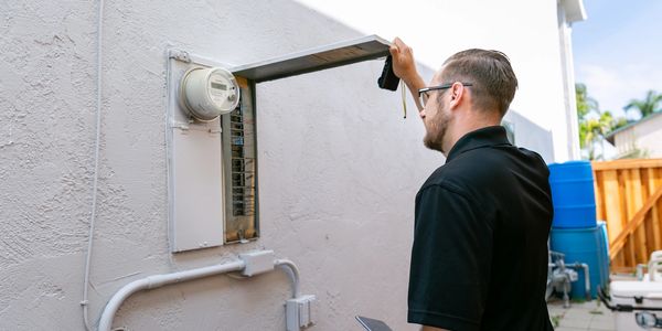 A person is checking the water meter