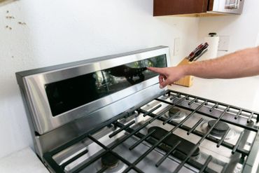 A person is inspecting the electric stove