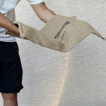 Pre-activated Quik-Response self-expanding sandbag being placed in water.