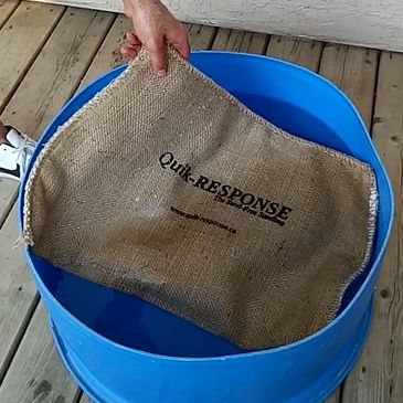 Submerging Quik-response self-expanding sandbag in water for activation.