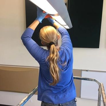 woman cleaning light