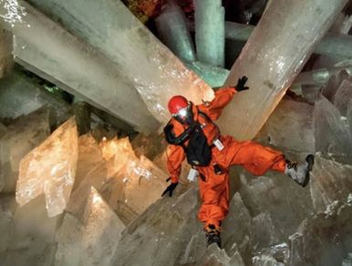 A man wearing an orange suit getting crystals