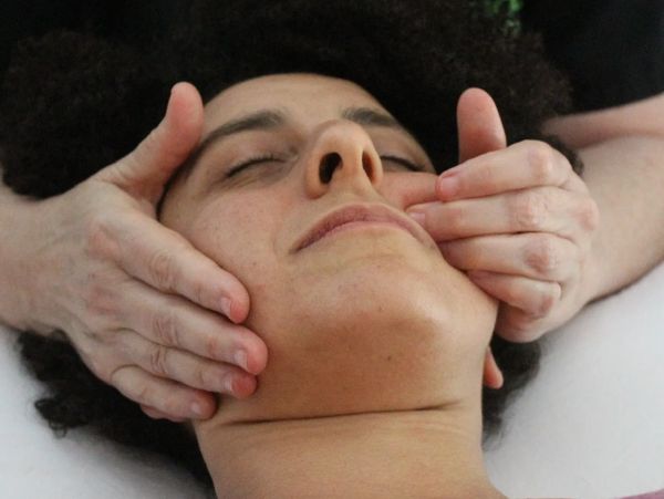 Person receiving TMJ massage therapy in Sugar Land, TX at Wholly Spirit Hands.
