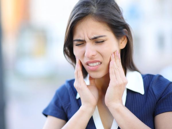 Person suffering from TMJ pain