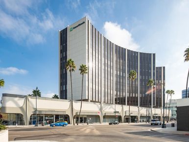 Modern TD Ameritrade office building with palm trees on a sunny day.