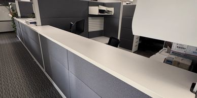 Modern office reception desk with clean, minimalist design.