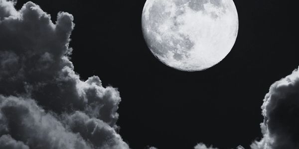 Bright full moon with clouds at night.